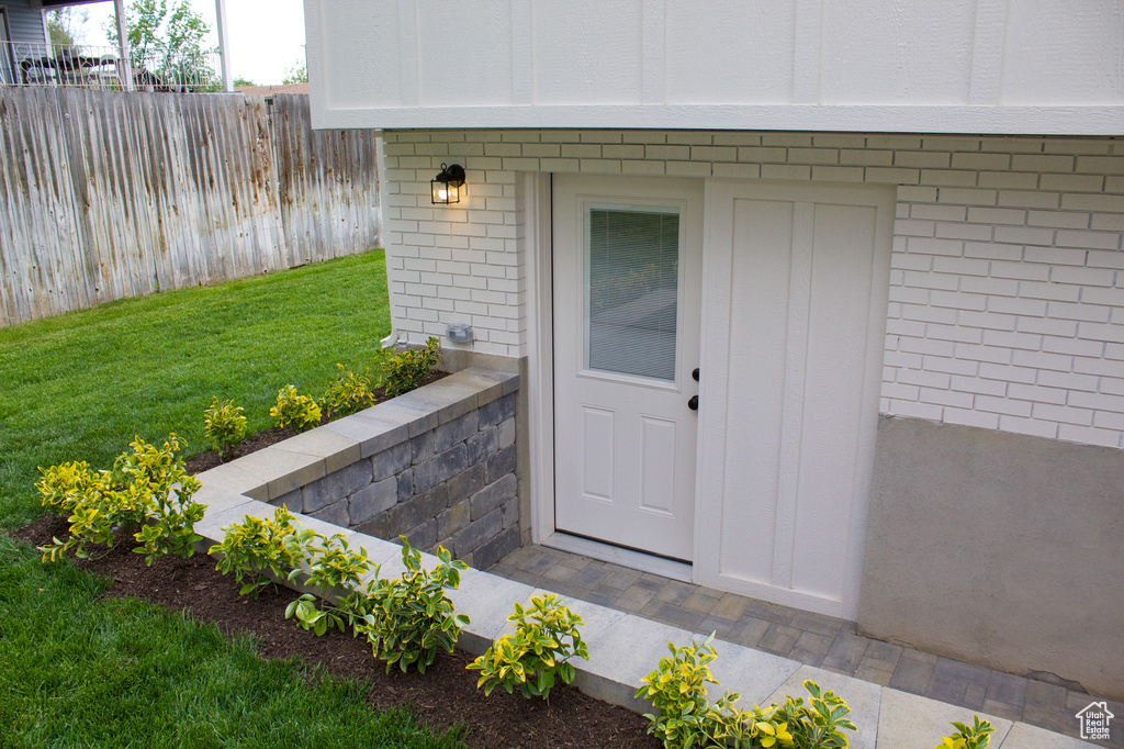 View of exterior entry with brick siding