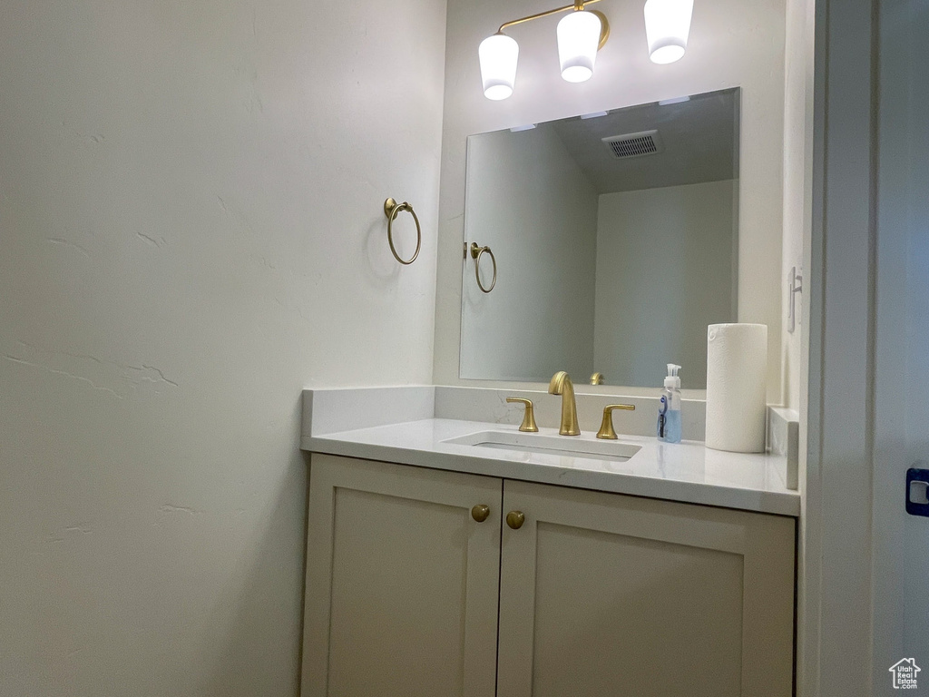 Bathroom featuring vanity and baseboards