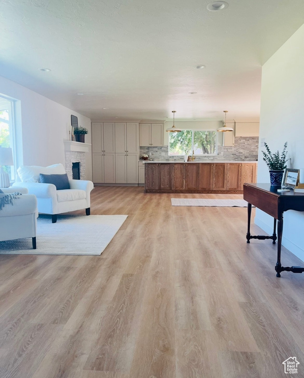 Living room with light wood finished floors and a fireplace