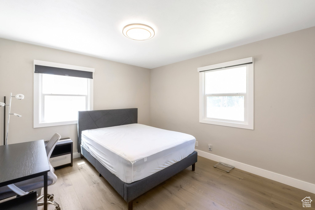 Bedroom featuring light wood-style floors and baseboards