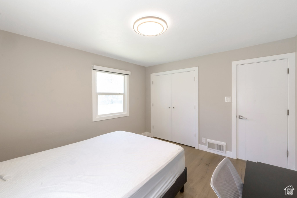 Bedroom featuring light wood-style floors and a closet