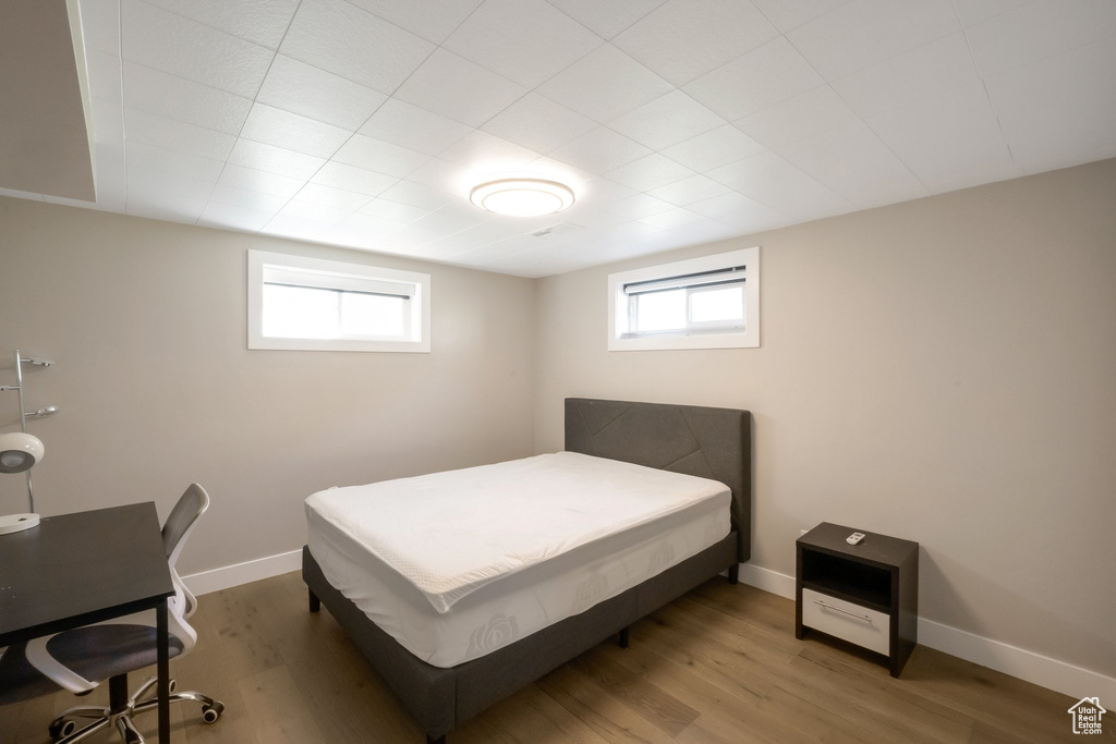 Bedroom featuring wood finished floors and baseboards