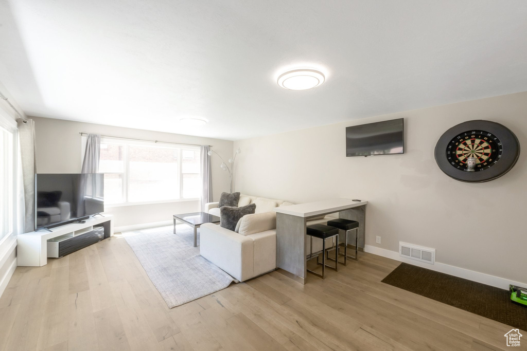 Living area with healthy amount of natural light, wood finished floors, and baseboards