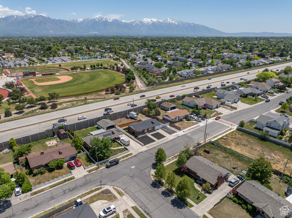 Aerial perspective of suburban area featuring a mountain backdrop