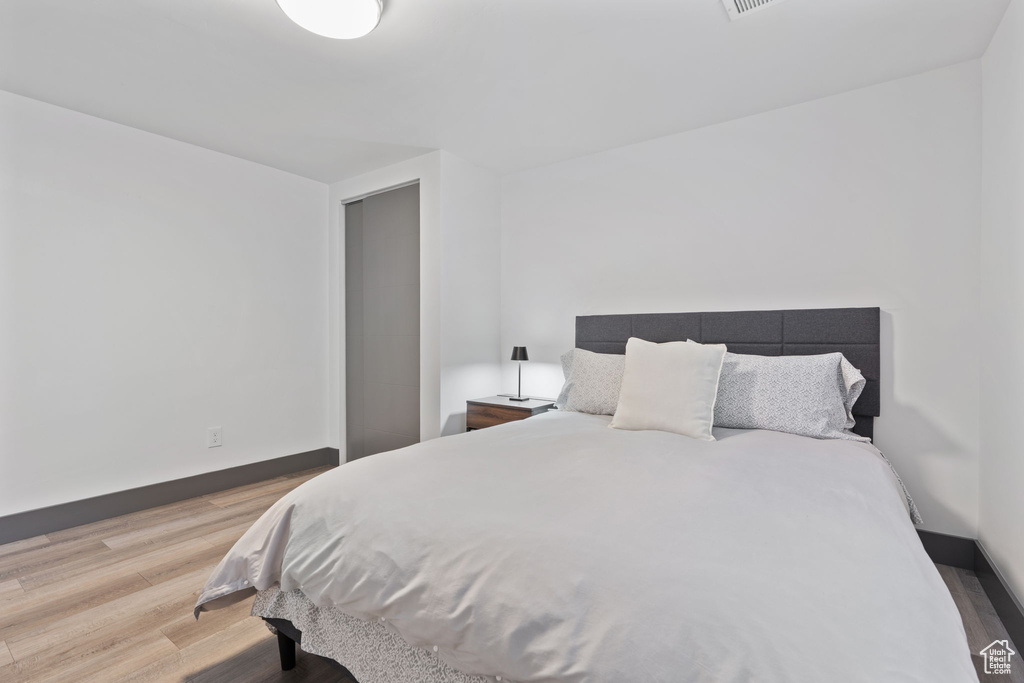 Bedroom featuring light wood-type flooring and baseboards