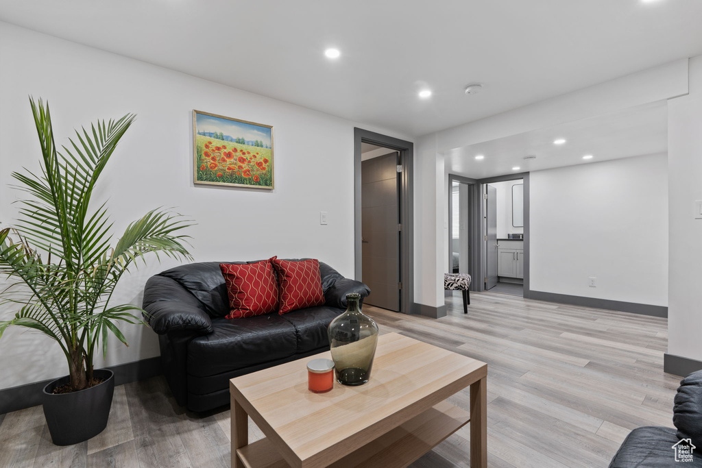 Living area featuring light wood-style flooring, recessed lighting, and baseboards