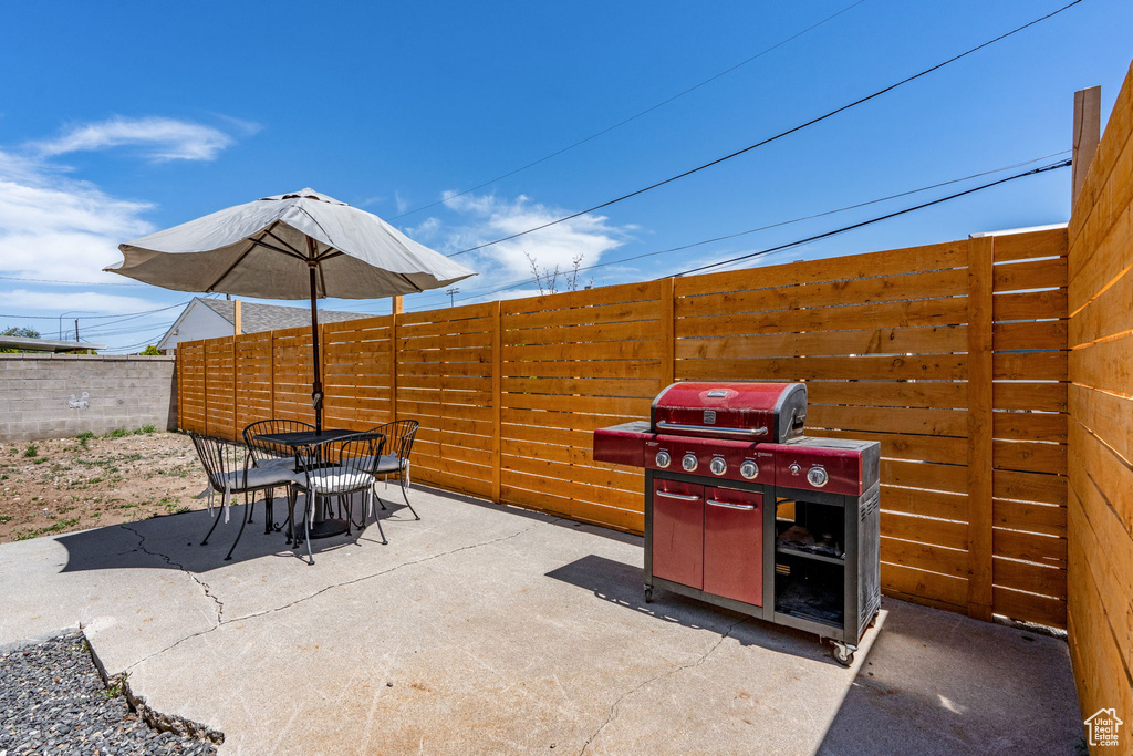 Fenced backyard with outdoor dining area, a patio, and area for grilling