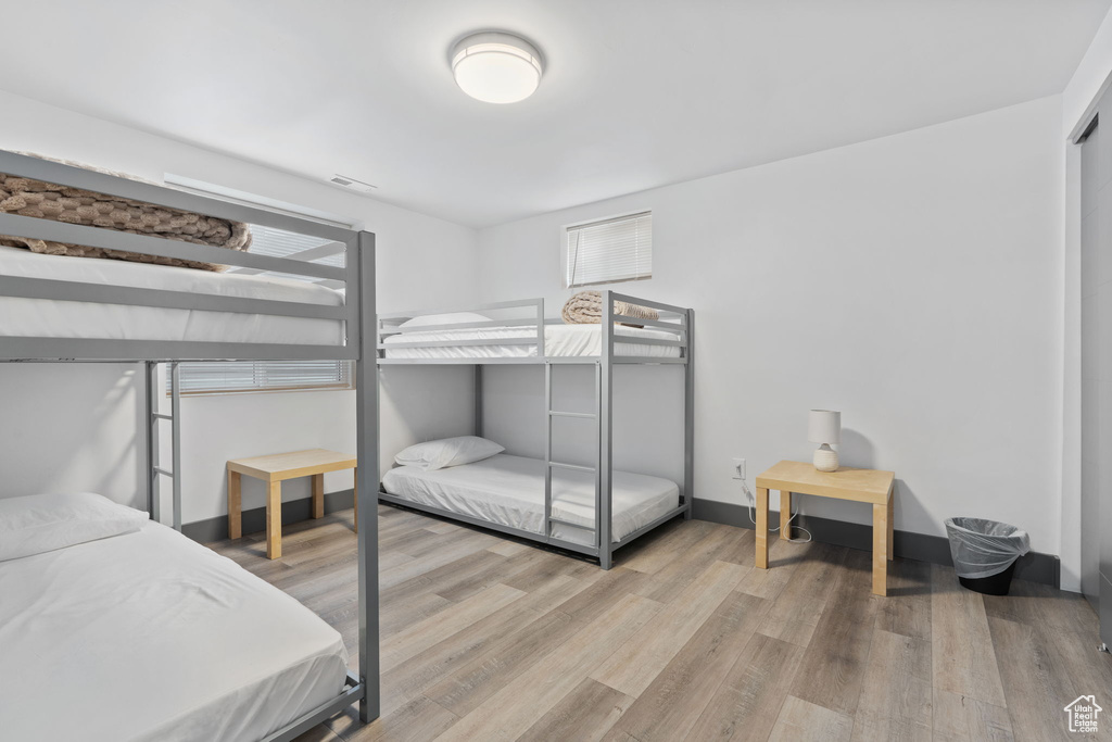 Bedroom featuring wood finished floors and baseboards
