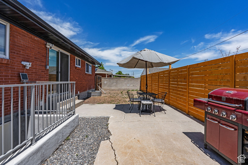 View of patio / terrace with entry steps, outdoor dining area, and area for grilling