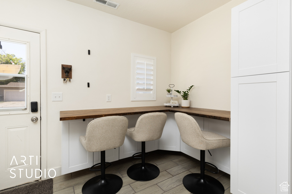 Home office featuring wood finished floors and baseboards