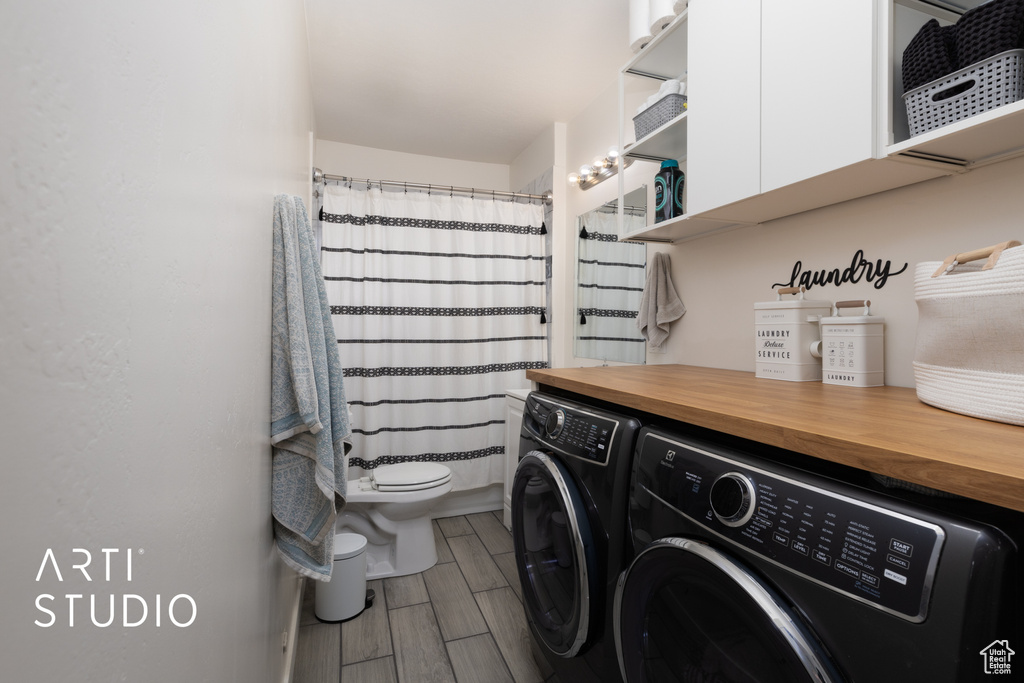 Laundry room with washer and clothes dryer