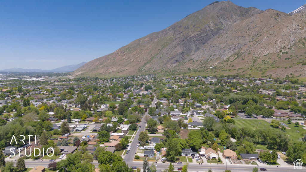 Aerial overview of property\\\'s location featuring a mountainous background and nearby suburban area