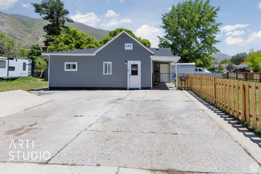 View of front of house featuring a mountain view and driveway