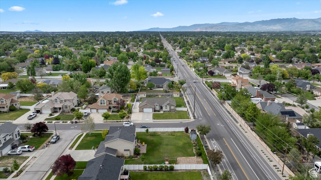 Aerial view of residential area with a mountainous background and a major roadway