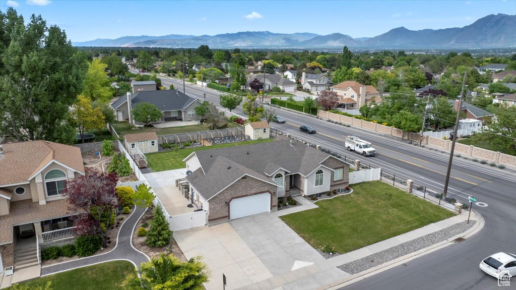 Aerial perspective of suburban area featuring a mountainous background