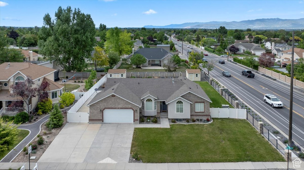 Aerial view of residential area featuring a mountainous background