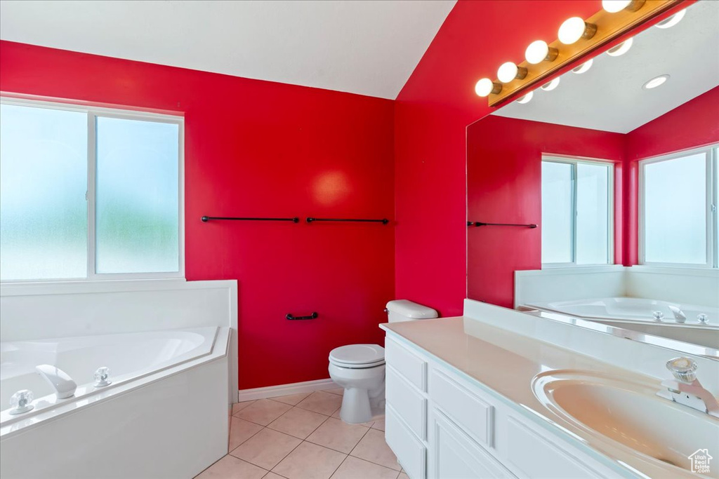 Bathroom with vanity, a garden tub, toilet, tile patterned floors, and baseboards
