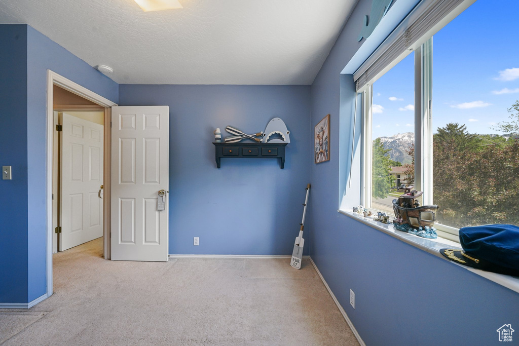 Bedroom featuring carpet and baseboards