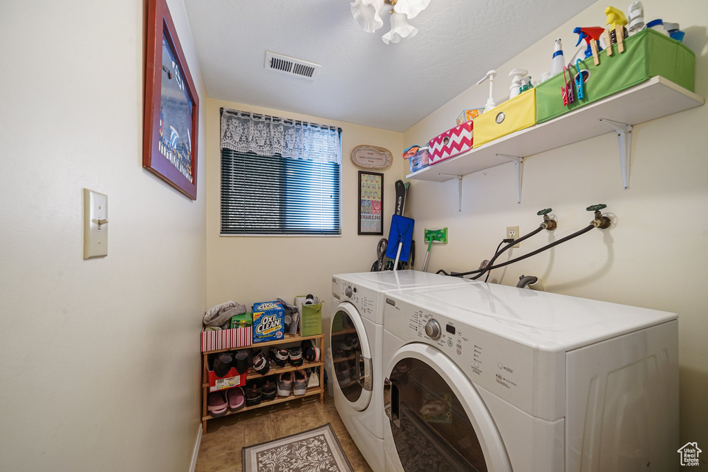 Laundry area featuring separate washer and dryer and baseboards