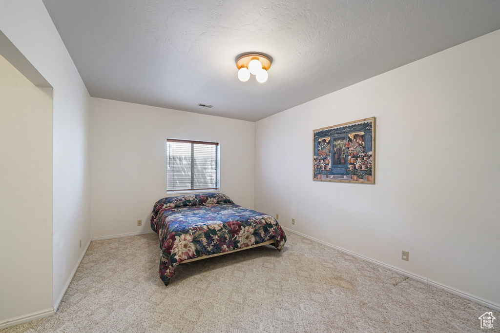 Carpeted bedroom with baseboards