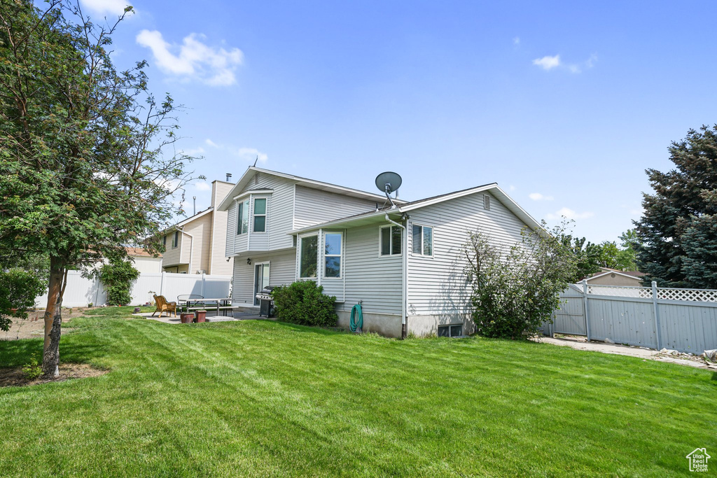 Rear view of house featuring a chimney and a patio