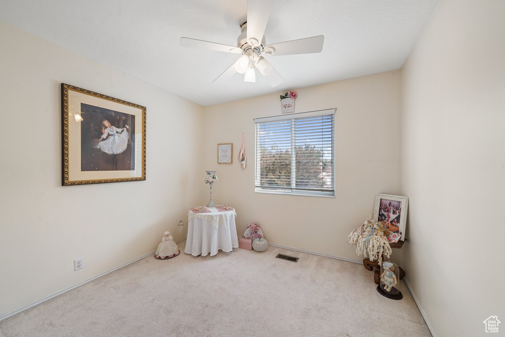 Recreation room with carpet, a ceiling fan, and baseboards
