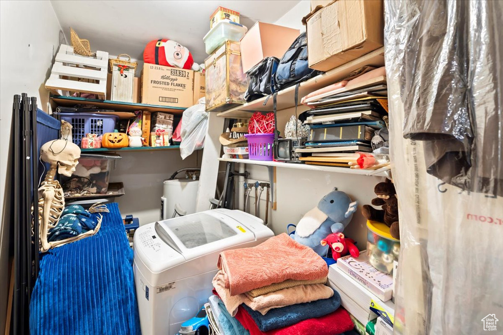 Storage room featuring washing machine and clothes dryer