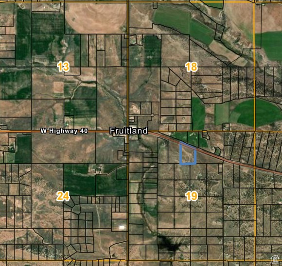 Aerial overview of property's location with property parcel outlined