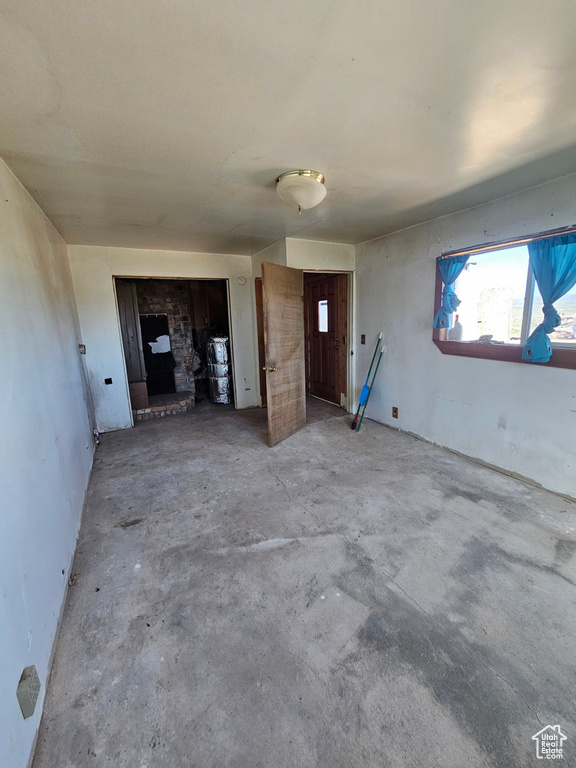 Unfurnished living room featuring concrete flooring