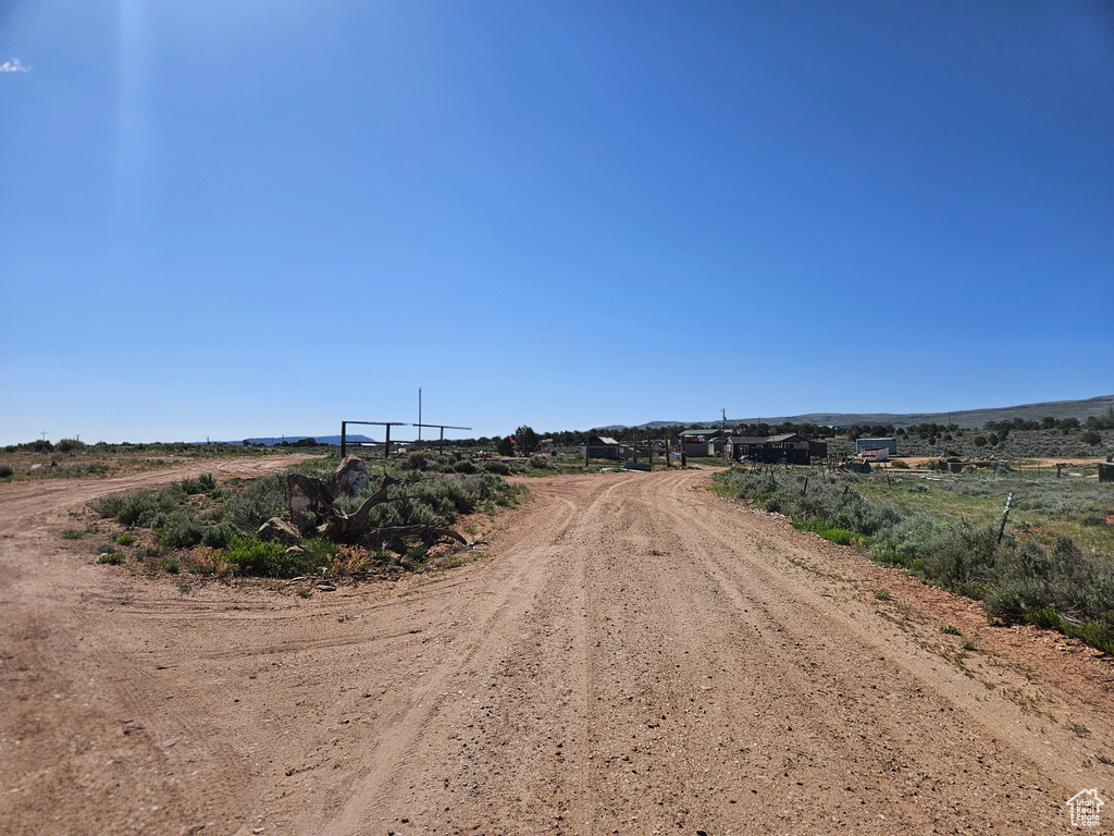 View of dirt / gravel road with a view of rural / pastoral area
