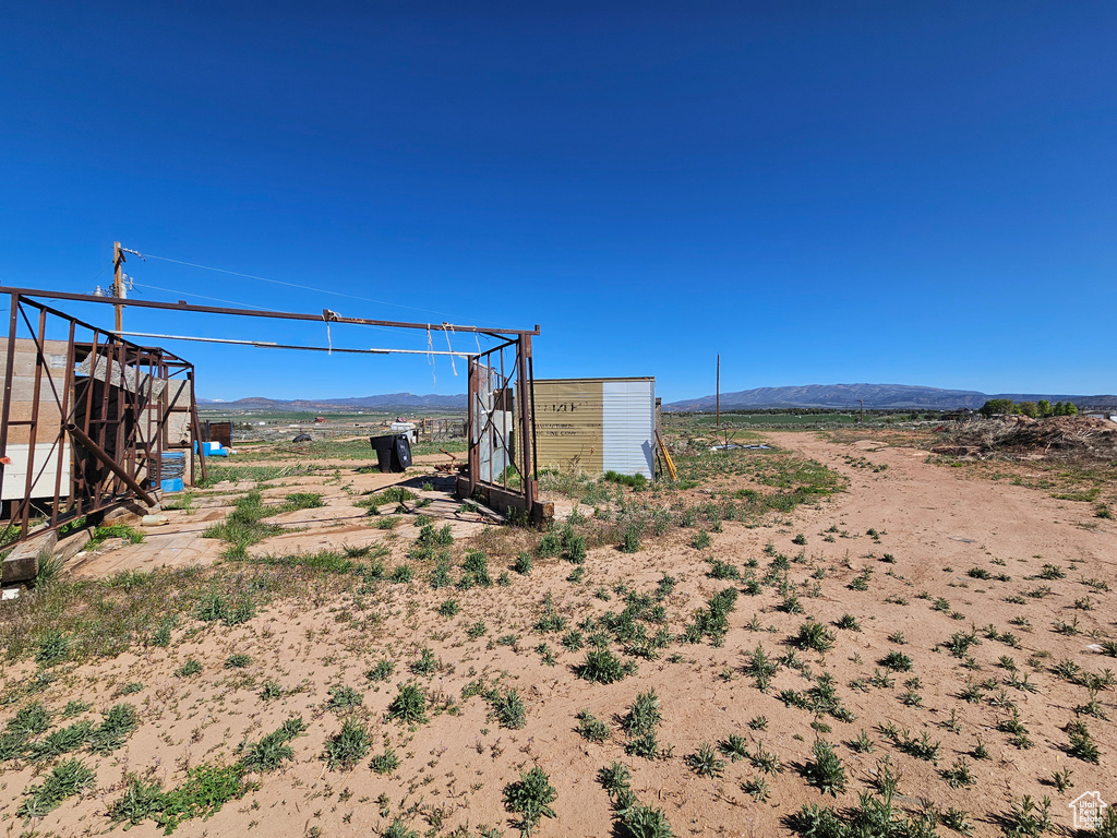 View of yard with a mountain view and an outbuilding