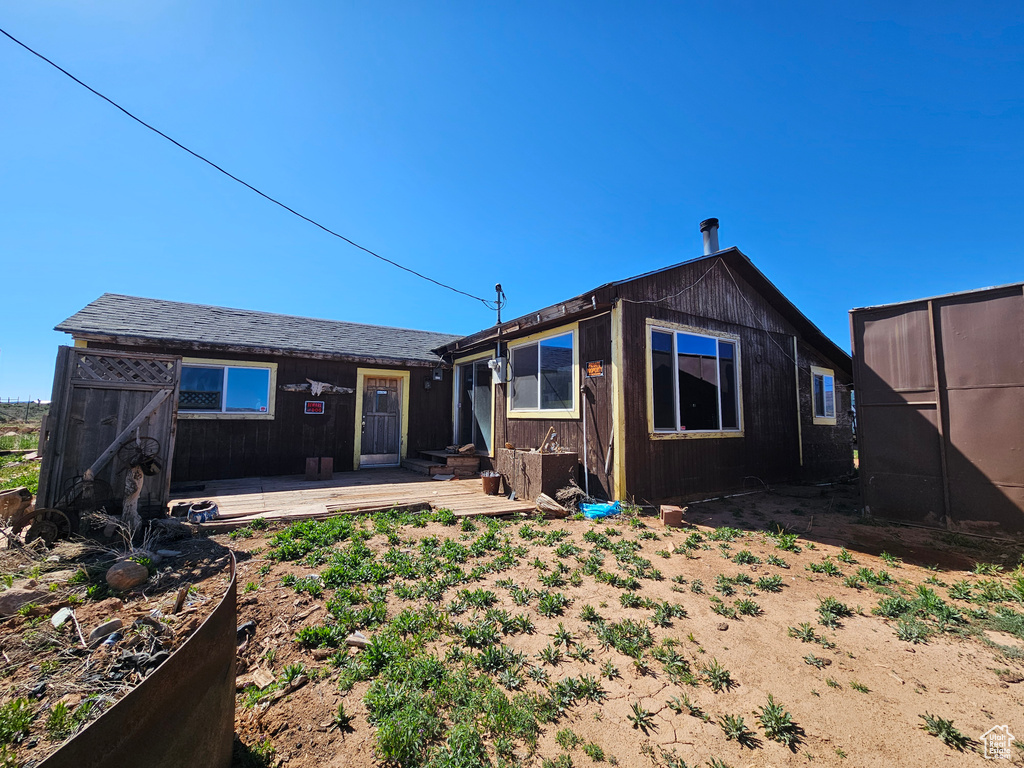Rear view of property featuring a deck