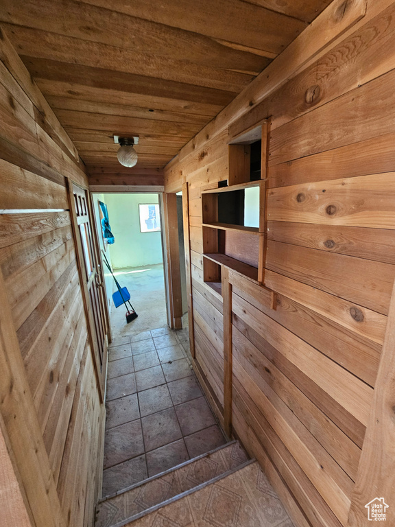 Hall featuring wood ceiling and wood walls