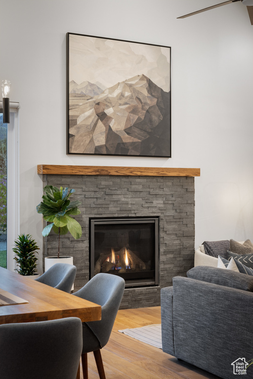 Living area featuring wood finished floors and a stone fireplace