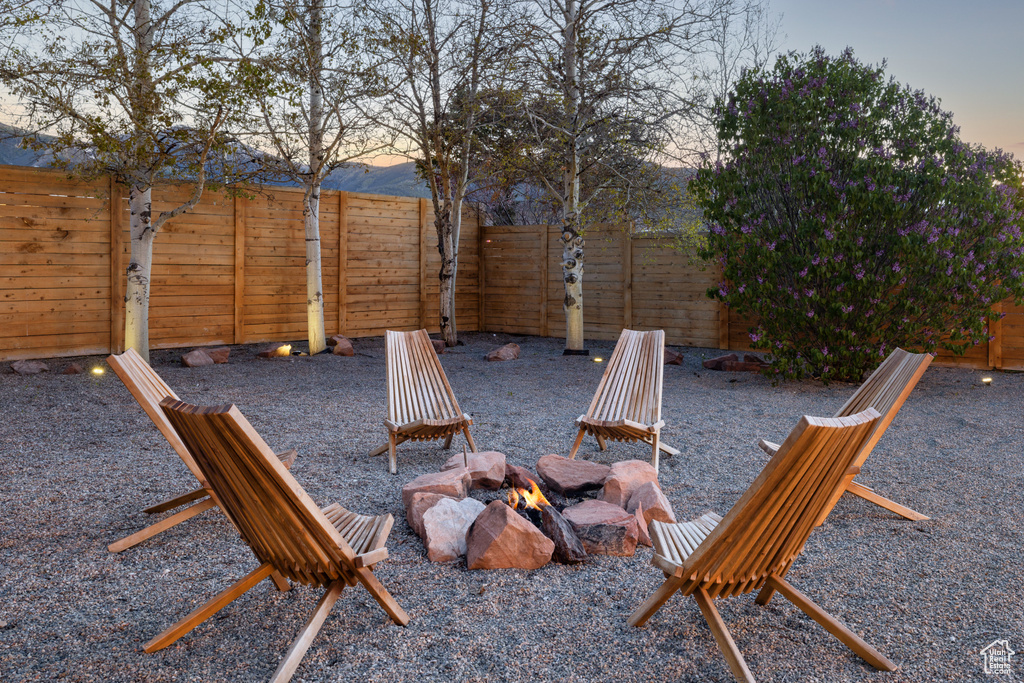 Fenced backyard featuring an outdoor fire pit