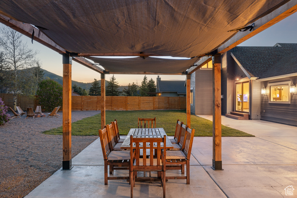 View of patio featuring outdoor dining space, a mountain view, and entry steps