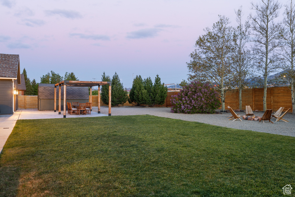 View of yard with a fire pit, a patio, and a pergola