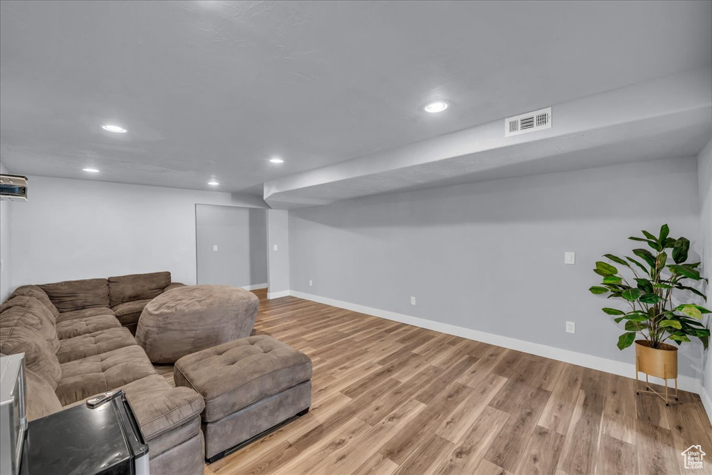 Living area featuring recessed lighting, light wood-style floors, and baseboards