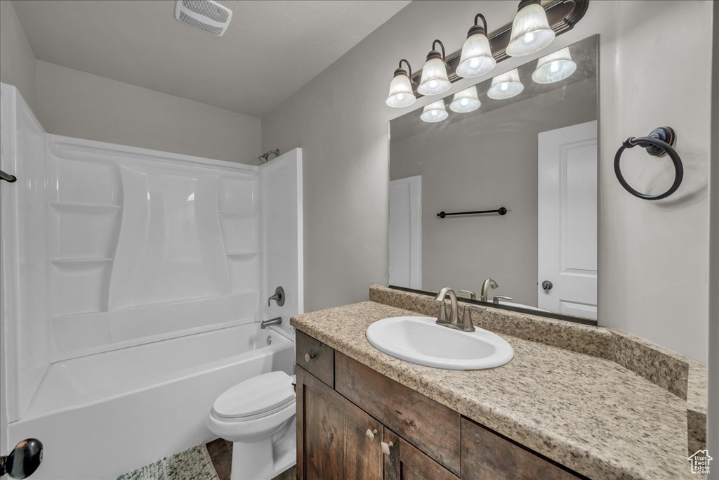 Bathroom with vanity, toilet, and shower / bath combination