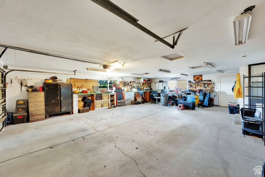 Garage with a workshop area and a garage door opener