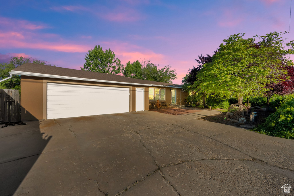 Single story home featuring a garage and stucco siding