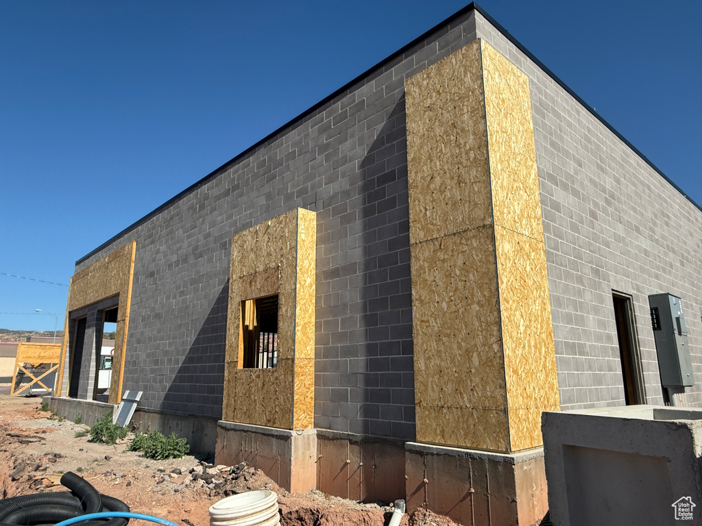 View of side of home with concrete block siding