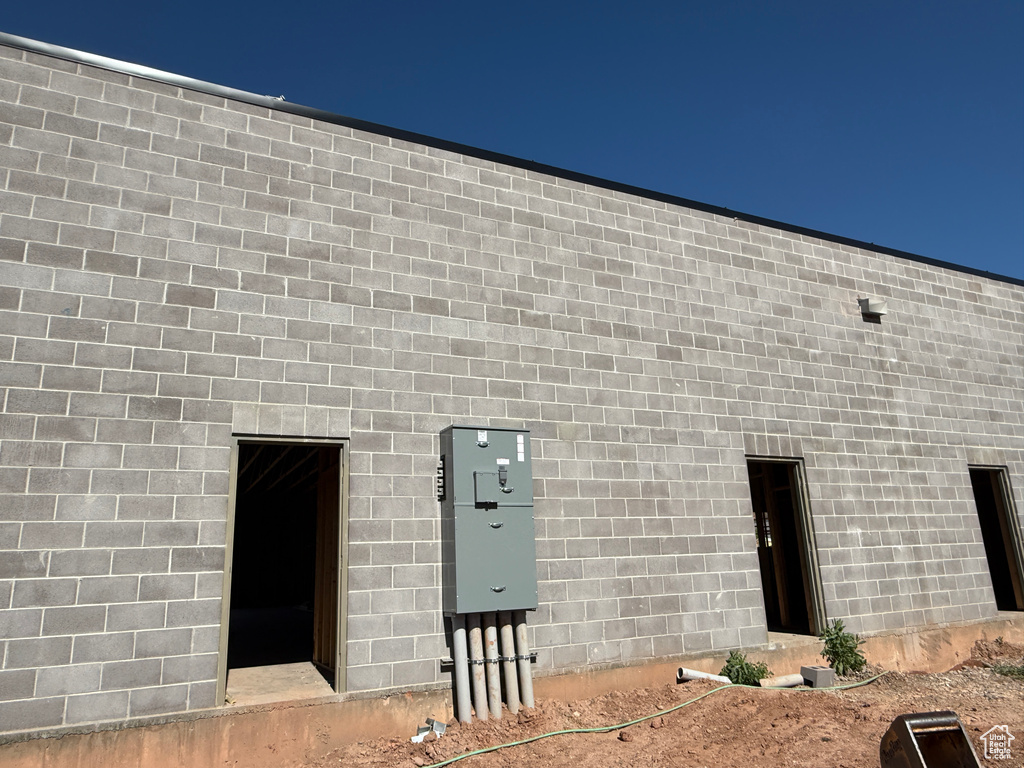 Back of house featuring concrete block siding
