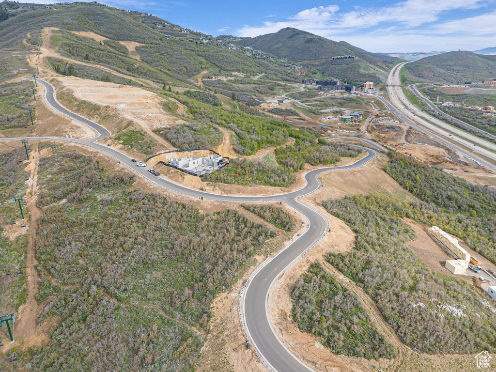 Aerial view of property's location featuring a mountainous background