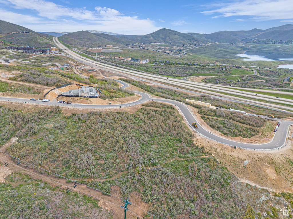 Aerial view of property and surrounding area with a mountain backdrop
