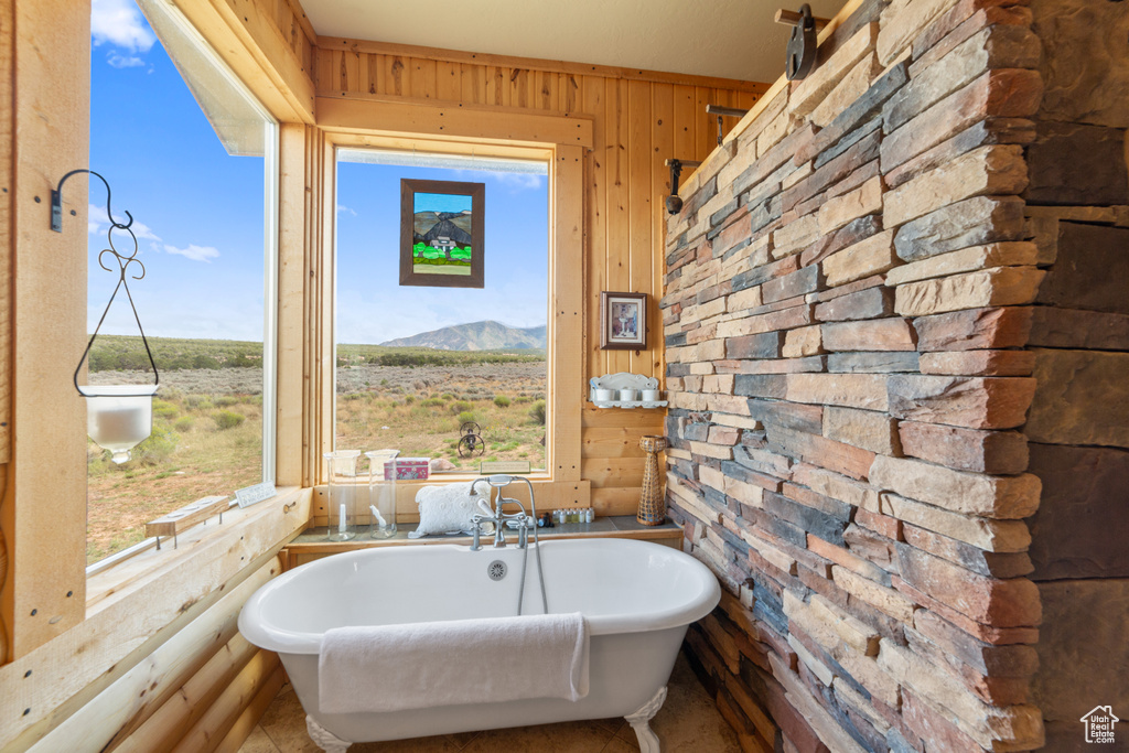 Bathroom with wooden walls and a freestanding bath