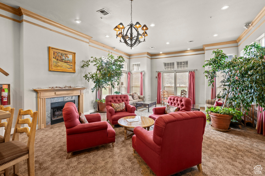 Living area featuring ornamental molding, a chandelier, recessed lighting, and a high end fireplace