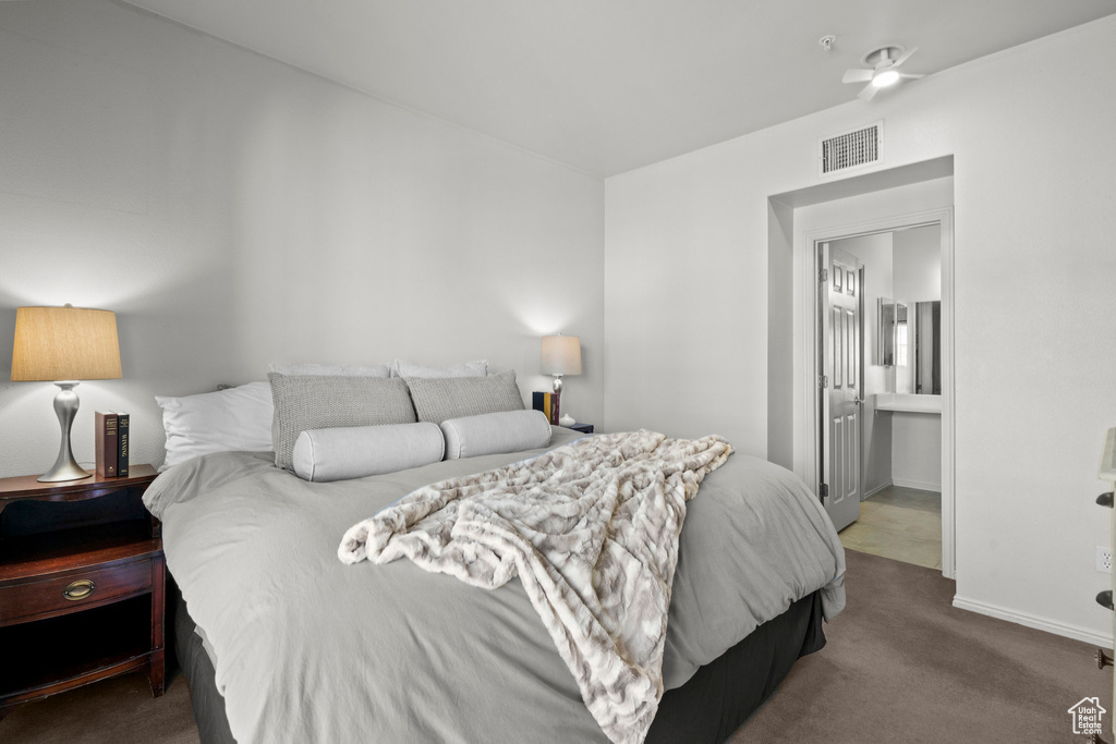 Bedroom featuring carpet flooring, ensuite bath, and baseboards