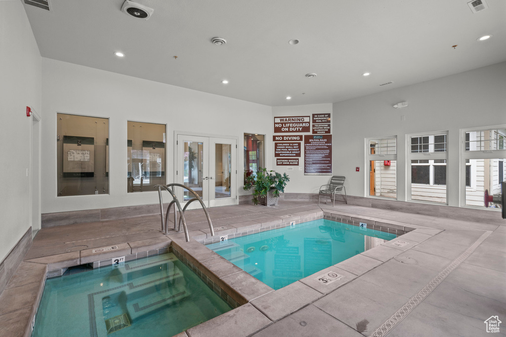 Indoor pool featuring french doors