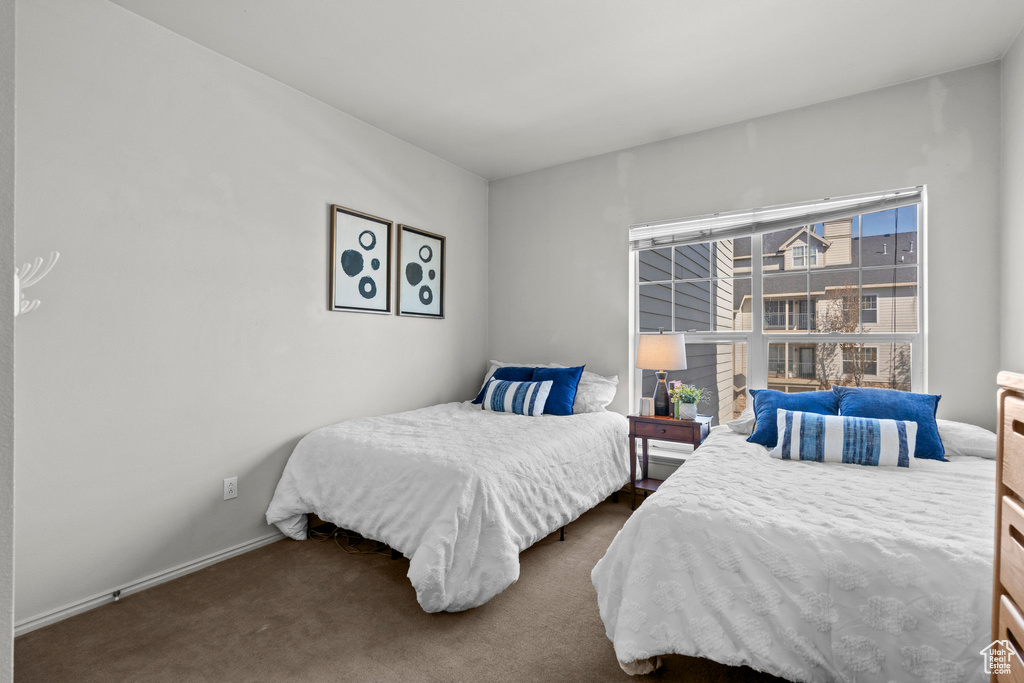 Bedroom with dark colored carpet